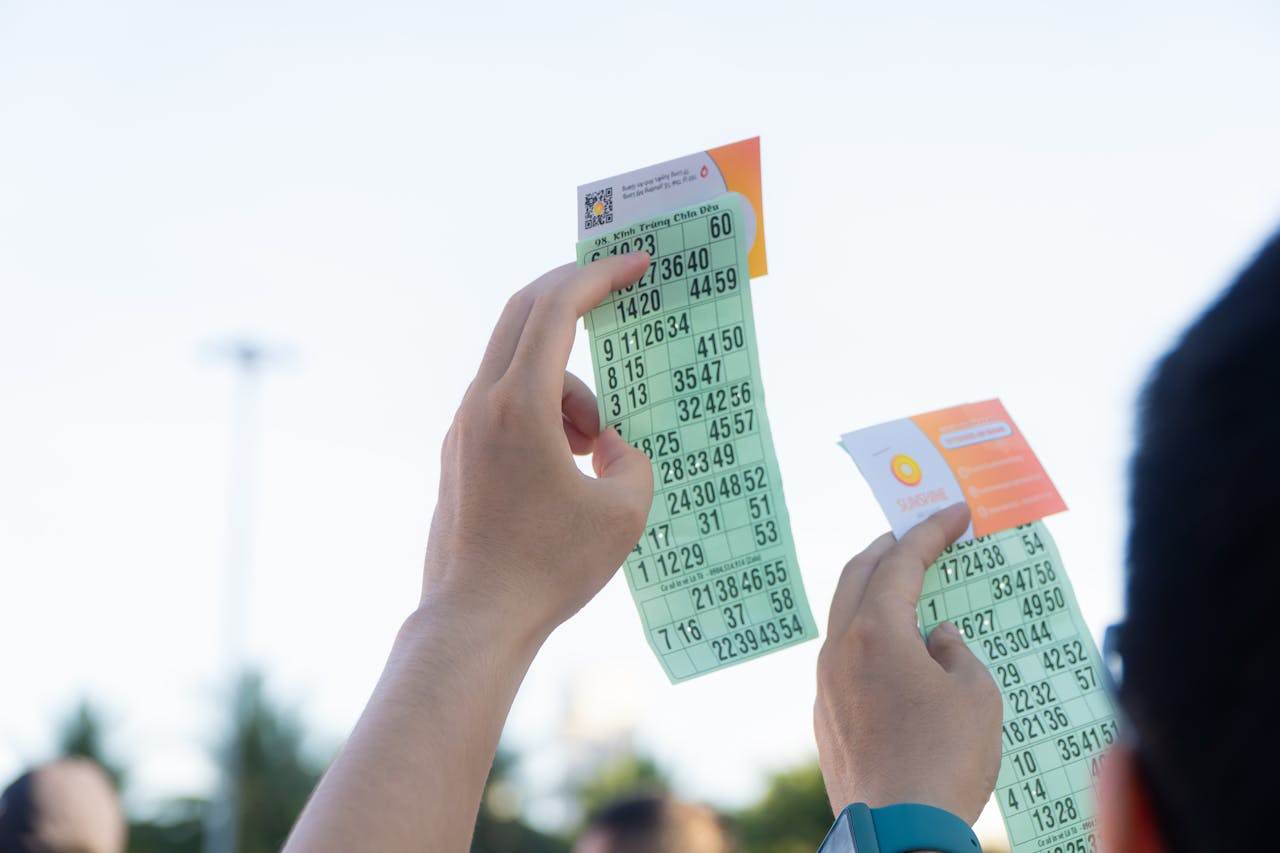 services-03 Close-up of hands holding transportation tickets, showcasing numbers and fare details.